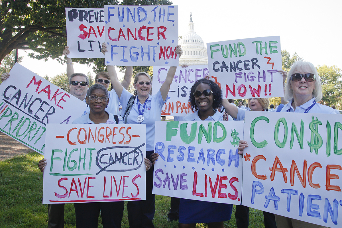 Volunteers holding signs