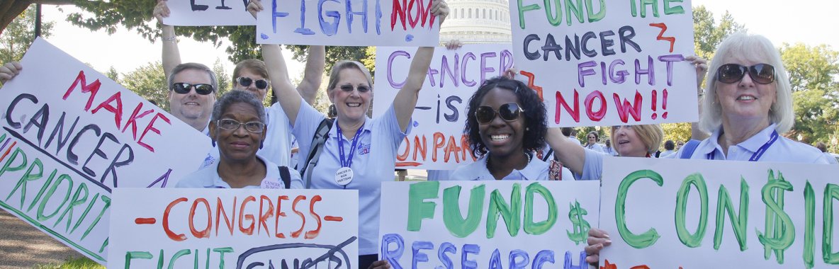 Volunteers holding signs at advocacy rally Volunteers holding signs at advocacy rally